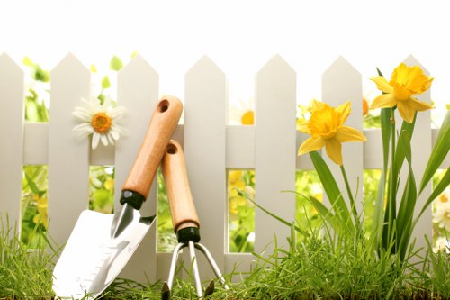 Insured gardeners preparing equipment for safe work in West Brompton